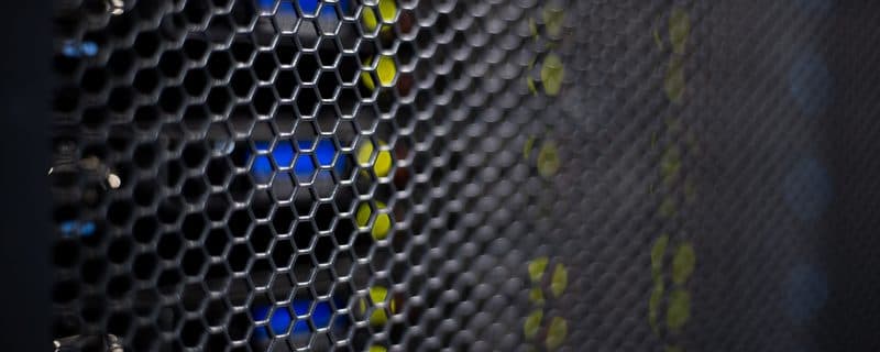 Blue and yellow status LEDs glowing through a tym2 server chassis mesh